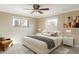 Serene bedroom with plush bedding, neutral tones, and plenty of natural light from two windows at 3765 S Depew St, Denver, CO 80235