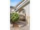 Inviting front entrance with stone steps, brick columns, green bush, and a stylish metal railing at 3765 S Depew St, Denver, CO 80235