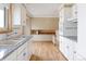 Bright kitchen with granite counters, updated cabinets, and stainless steel oven at 3765 S Depew St, Denver, CO 80235