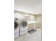 Laundry room complete with modern washer and dryer set and counter space at 3765 S Depew St, Denver, CO 80235