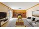 Cozy living room boasts a brick fireplace, neutral paint, and lots of natural light at 3765 S Depew St, Denver, CO 80235