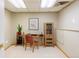 Home office features modern desk, chair, shelving and a cabinet with natural light at 3765 S Depew St, Denver, CO 80235