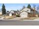 Street view of two-story homes with attached garages, tidy lawns, mature trees, and attractive curb appeal at 3765 S Depew St, Denver, CO 80235