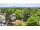 Aerial view of a home with a well-manicured lawn, mature trees, and a private backyard at 5987 W Ken Caryl Pl, Littleton, CO 80128