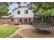 Large backyard with brick patio, outdoor grill, hot tub, trampoline, and a wooden deck for relaxing and entertaining at 5987 W Ken Caryl Pl, Littleton, CO 80128