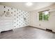 Bright bedroom with hardwood floors, decorated wall, a window and white dresser at 5987 W Ken Caryl Pl, Littleton, CO 80128