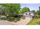 Beautiful home featuring a brick facade, well-kept lawn, and mature trees, offering great curb appeal at 5987 W Ken Caryl Pl, Littleton, CO 80128