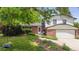 Charming two-story home featuring brick accents, a well-maintained lawn, and a welcoming front yard at 5987 W Ken Caryl Pl, Littleton, CO 80128