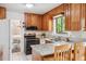 Traditional kitchen showcasing granite countertops and modern stainless steel appliances at 5987 W Ken Caryl Pl, Littleton, CO 80128