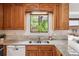 Close-up view of kitchen with oak cabinets, granite countertops, and stainless steel sink at 5987 W Ken Caryl Pl, Littleton, CO 80128