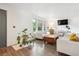 Sun-filled living room has hardwood flooring, white walls and modern furniture at 5987 W Ken Caryl Pl, Littleton, CO 80128