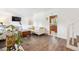 Comfortable living room with hardwood flooring and view to kitchen at 5987 W Ken Caryl Pl, Littleton, CO 80128