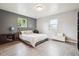 Spacious main bedroom with hardwood floors, large windows, and comfortable bed at 5987 W Ken Caryl Pl, Littleton, CO 80128