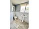 Bright bathroom with sink, toilet, medicine cabinet and tiled floors at 52 S Washington St, Denver, CO 80209