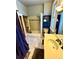 Traditional bathroom with a bathtub and shower combination, a pedestal sink, and a window at 52 S Washington St, Denver, CO 80209