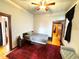 Cozy bedroom with a red rug, hardwood floors, and a ceiling fan at 52 S Washington St, Denver, CO 80209