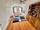 Attic bedroom featuring wood floors, 2 windows and a vintage cabinet for storage at 52 S Washington St, Denver, CO 80209