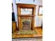 Detailed fireplace with decorative tile work and a wooden mantle at 52 S Washington St, Denver, CO 80209