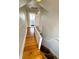 Hallway with wood floors leads to staircase and bathroom at 52 S Washington St, Denver, CO 80209