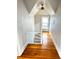 Hallway with wood floors, window and a white banister at 52 S Washington St, Denver, CO 80209