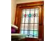 Close up of a stained glass window with geometric shapes in a wooden frame at 52 S Washington St, Denver, CO 80209