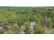 Aerial view of the home surrounded by green, mature trees at 1185 Fawnwood Rd, Monument, CO 80132