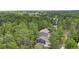 Aerial view of a home nestled among lush trees with a long driveway at 1185 Fawnwood Rd, Monument, CO 80132