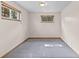 Unfinished basement bedroom with carpeted floors and natural light from the above-ground windows at 1185 Fawnwood Rd, Monument, CO 80132