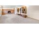 Spacious finished basement featuring built-in shelving and a cozy brick fireplace at 1185 Fawnwood Rd, Monument, CO 80132