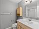 Clean bathroom with a single vanity, cabinet storage, and a shower with white shower curtain at 1185 Fawnwood Rd, Monument, CO 80132