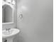 Compact bathroom with a white pedestal sink and neutral-toned walls at 1185 Fawnwood Rd, Monument, CO 80132