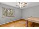 Bedroom with hardwood floors, neutral walls, and a large window providing natural light at 1185 Fawnwood Rd, Monument, CO 80132