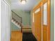 Inviting entryway featuring hardwood floors, stairs, and wooden front door at 1185 Fawnwood Rd, Monument, CO 80132