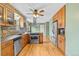 Well-lit kitchen with stainless steel appliances and hardwood floors at 1185 Fawnwood Rd, Monument, CO 80132