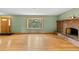 Hardwood floors, brick fireplace, and bay window in this comfortable living room at 1185 Fawnwood Rd, Monument, CO 80132