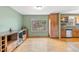 Sunlit living room offers hardwood floors, window, and kitchen access at 1185 Fawnwood Rd, Monument, CO 80132