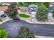 Aerial view of the house with a lush front lawn, driveway, and surrounding mature trees at 15918 E Flora Pl, Aurora, CO 80013