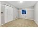 Neutral bedroom with a double closet, carpet floor, and a bright window at 15918 E Flora Pl, Aurora, CO 80013
