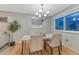 Bright dining room features hardwood floors, elegant lighting, and space for entertaining at 15918 E Flora Pl, Aurora, CO 80013