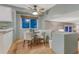 Dining area features hardwood floors, and a modern ceiling fan and lighting at 15918 E Flora Pl, Aurora, CO 80013