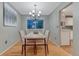 Cozy dining room features hardwood floors, elegant lighting, and access to the kitchen at 15918 E Flora Pl, Aurora, CO 80013