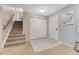 Inviting entryway with a carpeted staircase, tile floor, and closet for storage at 15918 E Flora Pl, Aurora, CO 80013