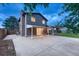 Rear view of the exterior showing an extensive concrete patio and well-kept backyard at 15918 E Flora Pl, Aurora, CO 80013