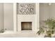 Decorative white-brick fireplace with unique design elements in the living room at 15918 E Flora Pl, Aurora, CO 80013