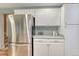 Kitchen features stainless steel refrigerator and ample white cabinet storage at 15918 E Flora Pl, Aurora, CO 80013