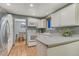 Well-lit kitchen with stainless steel refrigerator, stove, and view into the dining room at 15918 E Flora Pl, Aurora, CO 80013
