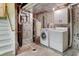 Functional basement laundry area with a washer, dryer, and water heater for convenience at 15918 E Flora Pl, Aurora, CO 80013