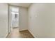 Hallway to the laundry room with tile flooring, utility closet and access to the bathroom at 15918 E Flora Pl, Aurora, CO 80013