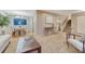 Open-concept living area features hardwood floors, plush carpeting, and stairway to upper level at 15918 E Flora Pl, Aurora, CO 80013