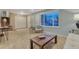 Inviting living room with neutral tones, plush carpeting, and ample natural light through a large window at 15918 E Flora Pl, Aurora, CO 80013